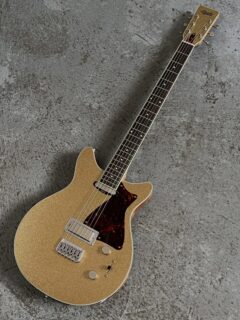 I just wrapped up the first 28” scale Baritone Growler and it came out grand. This one is for our new friend Josh M @joshmilan6969 who we met through our old friend Ernie Jackson @jamsire_ernoir Ernie has the very first Baritone I made while attending Roberto-Venn and Josh got to play it and fell head over heels! I’ll write more about Ernie and that guitar soon.

As much as I am proud of my work from 25 years ago, I didn’t want to revisit the same body shape as it really doesn’t represent what we do now.  I also didn’t have templates from the old days! Thankfully Josh was willing to go with the Growler shape. I always thought the combination of materials was really key to the bass response and feel of the original guitar, so I stuck with a chambered Mahogany body, Maple top, Maple neck and Ebony fretboard (this time Macassar Ebony but close enough). Continued in next slide…

The pickup combination was unique too, and I have no memory of why I chose a Firebird Bridge and Telecaster neck back then but the pickups work great for the low end, and the bridge gives the twang you’d hope for to cut through a mix. We chose @lollarpickups for what I think of as their Hi-Fi qualities. They’re very touch responsive and paired with @vintageinspiredpickups 280k pots they just have a great wide spectrum of tones.

I used a Hipshot bridge because the plate is a taller 0.175” so I could keep the neck angle closer to our standard set-neck pitch. The neck is big, and with a 1 3/4” nut width there’s room for the heavier strings and the taper of the fretboard feels less pronounced, something Josh had responded to on the original guitar. We also used Hipshot locking tuners. The 28” scale is tuned to B-b with D’Addario 13-62 strings. The standard 25.5” scale Growler joins the body at the 21st fret, but I wanted to make sure we had a larger tenon to withstand the string tension and balance well, so I moved the joint to the 20th fret and lengthened the joint. Continued in the next slide…

The whole instrument is bound with Ivoroid, sprayed with a Champagne Sparkle Metallic lacquer, and has a gloss clear coat throughout. We used 95x45 fretwire and a 10-12” compound radius fretboard. I al